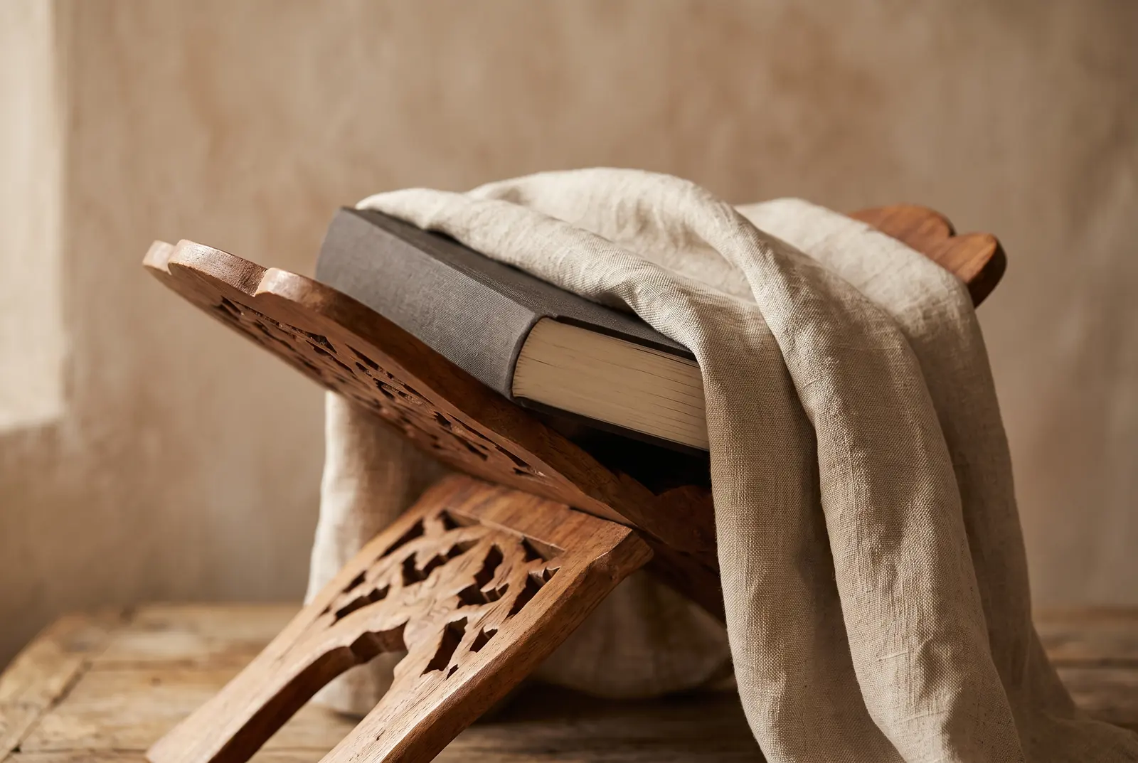 A close view of an open mushaf, the script catching low warm light.